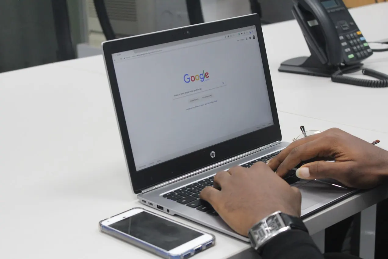homem pesquisando no Google usando um laptop